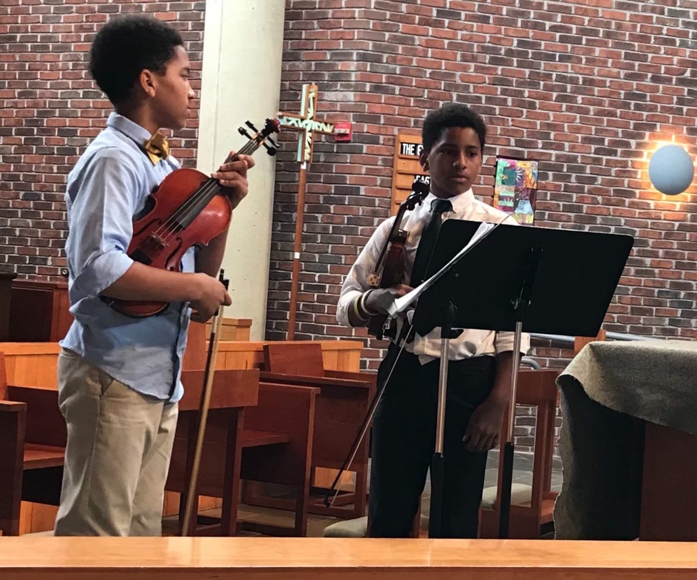 Emily Campbell with two students