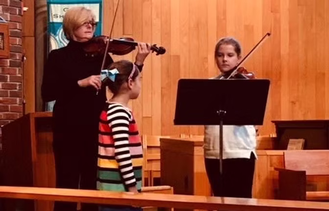 Emily Campbell teaching violin